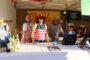 Volunteers serving wine at the Halloween Festival