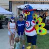 Mascot Purdy and man, woman, and child posing for a picture