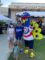 Mascot Purdy and man, woman, and child posing for a picture