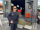 Policer officer standing in back of truck