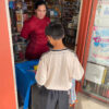 Woman giving out candy to a young boy