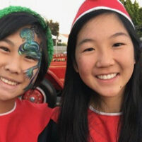 Arcadia Holiday Market fun showing two kids wearing red with face painting