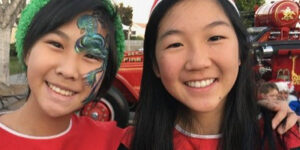 Arcadia Holiday Market fun showing two kids wearing red with face painting
