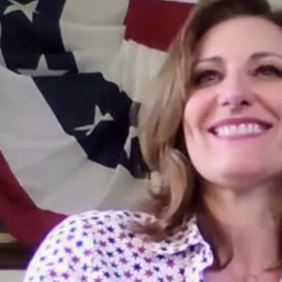 Downtown Arcadia video series showing a woman with long brown hair in front of a patriotic banner