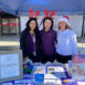 Three woman with Santa hat and deer hats on posing for a picture